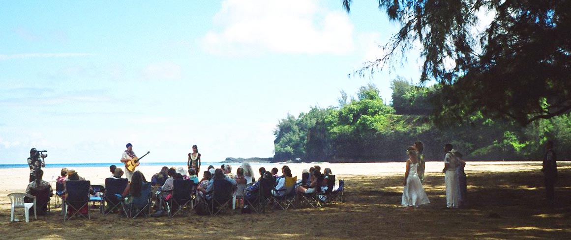 Kalihiwai beach with seated wedding guests